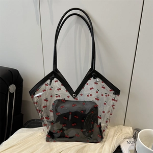 Transparent PVC tote bag with cherry print and black leather straps on silk fabric