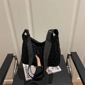 Women's black leopard print nylon tote bag with wide adjustable shoulder strap