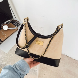 Crossbody bag with leopard print top and black leather base featuring gold twist lock