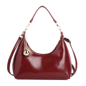 Glossy deep red patent leather crescent hobo bag with adjustable shoulder strap