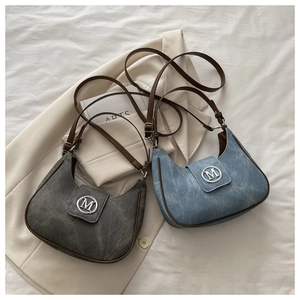 Detailed top view of hobo crescent bags with silver M logo on stylish blazers
