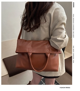 Brown litchi grain PU leather tote bag with top handle and strap shown from behind