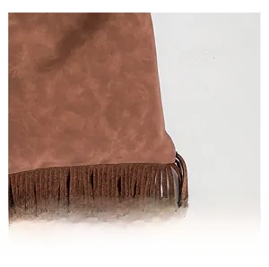 Detailed close-up showing the brown suede fabric texture and long fringe design of the bag