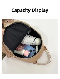 Capacity display of the beige soft leather backpack showing umbrella and essentials