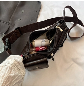 Deep brown pebble leather crossbody bag showing spacious interior with daily essentials