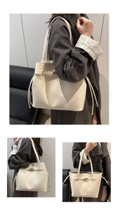 Detailed views of a minimalist cream bucket bag with golden buckle and textured leather
