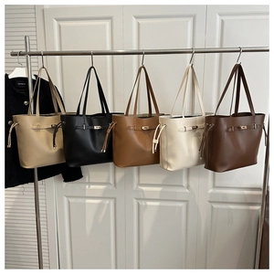 Collection of large capacity leather bucket bags in multiple colors with metal twist locks