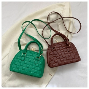 Top view of green and brown checkered shell bags with luxury gold zipper details