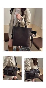 Detail showing the textured dark brown leather and versatile folding design of the tote bag
