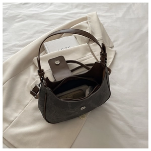 Detail showing the internal storage capacity and magnetic flap of the grey crescent bag
