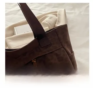 Detailed close-up of brown leopard print tote bag with woven drawstring and textured finish