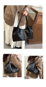 Macro detail of large black leather tote bag showing front and side shoulder carry views