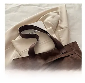 Detail view of the brown leopard print tote bag with soft handles and drawstring details