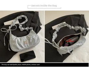 Detailed interior and exterior view of a silver pleated crescent shoulder bag for women