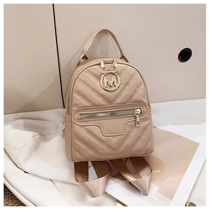 Detail of beige mini backpack with chevron stitching and golden M logo on white suit