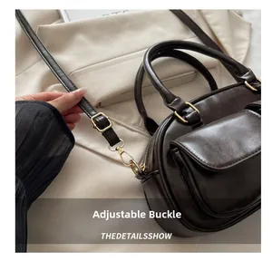 Detail of adjustable buckle and dark brown leather texture on versatile shoulder bag