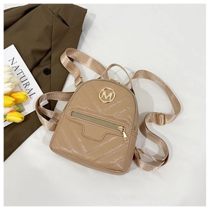 Detail of beige quilted backpack with gold M logo and elegant v-shaped stitching texture