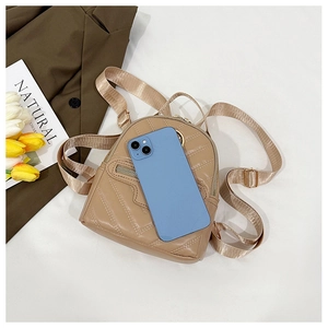 Close-up of khaki quilted mini backpack with golden hardware and phone for scale