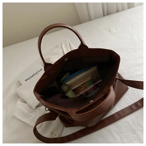 Interior view of brown lychee leather tote bag showing spacious storage with magnetic closure