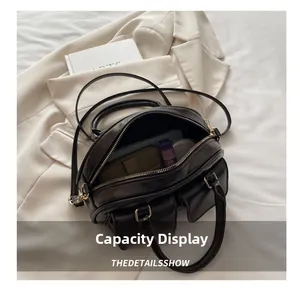 Detailed interior of a vintage brown leather bag showing large capacity for daily items