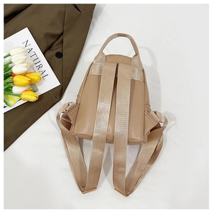 Detail of khaki synthetic leather backpack with adjustable straps and tulip decor