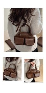 Detail view of a vintage brown leather Boston bag with functional pockets and gold hardware