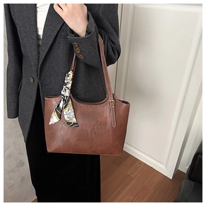 Détail d'un sac cabas en cuir marron avec foulard en soie élégant pour le travail