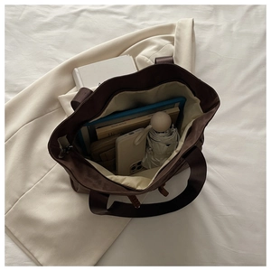 Top view of spacious dark brown tote bag showing capacity for tablets and books