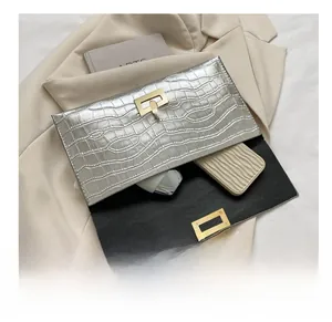 Silver crocodile texture envelope clutch bag with gold buckle and internal storage view