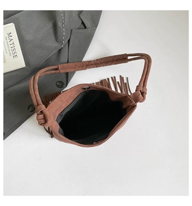 Top view of brown suede bucket bag with long tassels and thick rope knotted handle