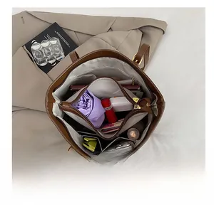 Detailed interior of the brown leather tote bag showing spacious compartments and storage