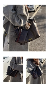 Detail view of large faux leather tote bag with a small zipper pouch and teddy bear charm