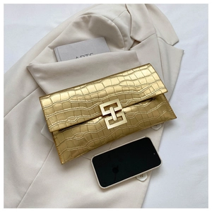 Detail of gold faux crocodile texture envelope clutch bag with metal clasp and flap
