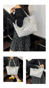Detailed interior view and handle accents of a woven houndstooth tote with gold rivets