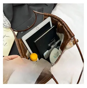 Interior view of large brown tote bag showing spacious capacity for iPad and daily items