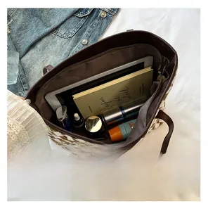 Spacious interior of woven tote bag with houndstooth pattern showing tablet and cosmetics