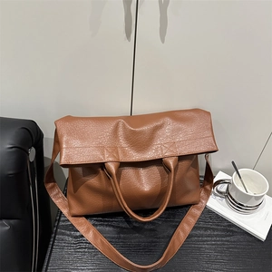 Brown textured large tote bag with wide shoulder strap and soft pleated PU leather finish