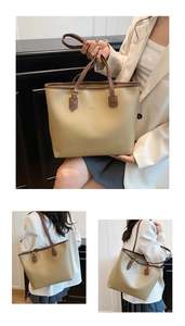 Detail of high-capacity tote bag with khaki synthetic leather and brown straps