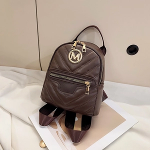 Premium dark brown quilted leather backpack with gold M logo and V-shaped stitching detail