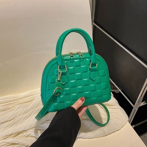 Stylish emerald green quilted handbag with gold zippers and cross-body strap