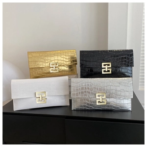 Detail view of stylish envelope clutches with crocodile texture in multiple colors