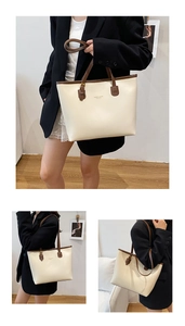 Detail of minimalist tote bag with premium cream PU leather and gold embossed branding
