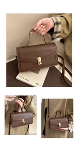 Detail of dark brown leather crossbody bag with elegant gold metal buckle and long strap