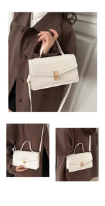 Three-way style view of a white rectangular crossbody bag with gold clasp and top handle