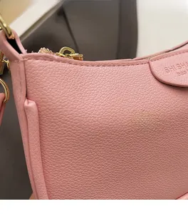 Detail of pink lychee texture leather bag with gold metal zipper and stitching
