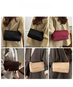Close-up of minimalist suede flap bag with elegant gold chain strap in multiple colors