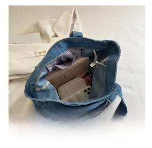 Interior detail of a large denim tote bag showing spacious capacity for daily essentials