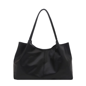 Minimalist black faux leather tote bag with vertical stitching for daily office commuting