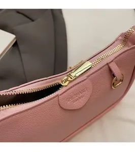 Close-up of pink leather bag with premium gold zipper and embossed fashion lettering