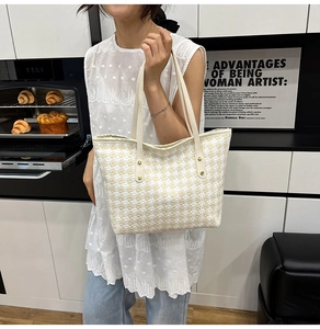 Detail of woven tote bag with checkered pattern in a minimalist lifestyle setting